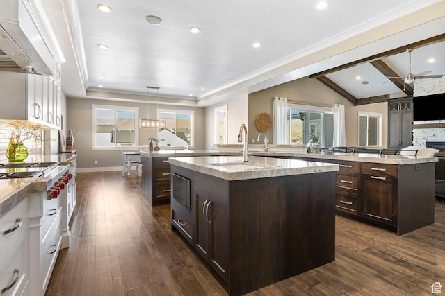 1595 E Duggan Dr, Eagle Mountain, UT 84005 - kitchen featuring dark hardwood / wood-style floors, an island with sink, custom range hood, and white cabinets