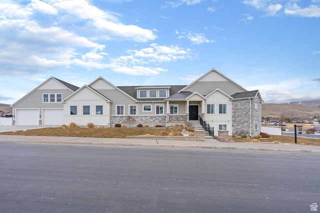 1595 E Duggan Dr, Eagle Mountain, UT 84005 - view of front facade with a mountain view, a garage, and covered porch