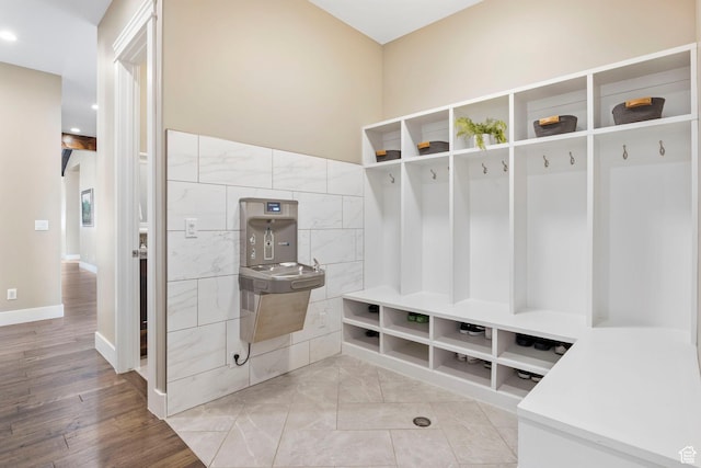1595 E Duggan Dr, Eagle Mountain, UT 84005 - mudroom with tile walls and light hardwood / wood-style floors