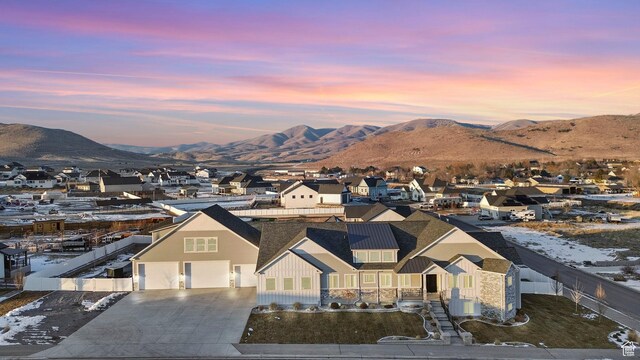 aerial view at dusk featuring a mountain view