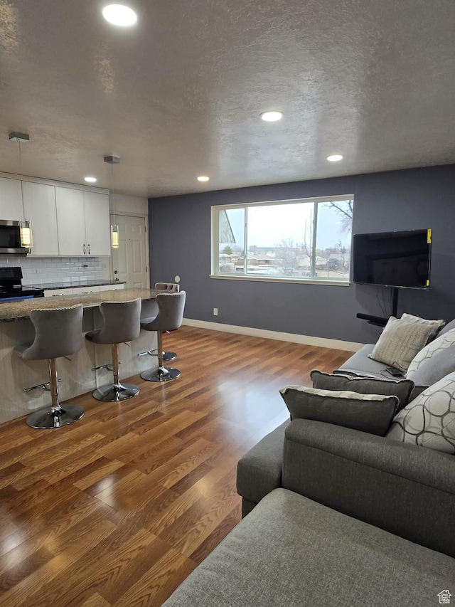 3673 S 2200th St W Unit 13, West Valley City, UT 84119 - living room with hardwood / wood-style flooring and a textured ceiling