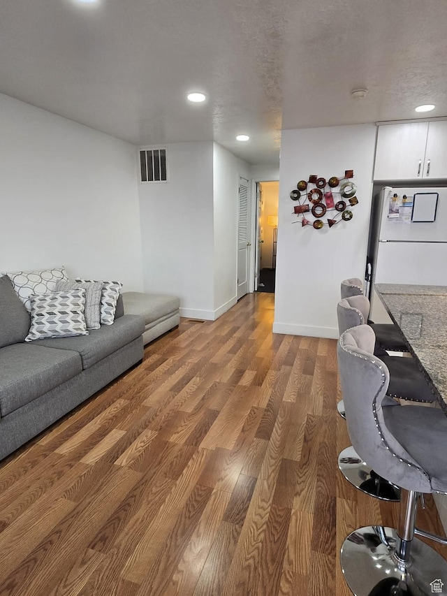 3673 S 2200th St W Unit 13, West Valley City, UT 84119 - living room featuring hardwood / wood-style flooring and a textured ceiling