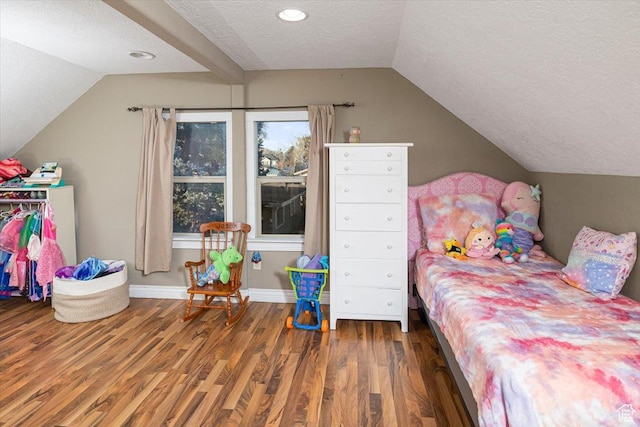 bedroom featuring lofted ceiling, dark hardwood / wood-style floors, and a textured ceiling