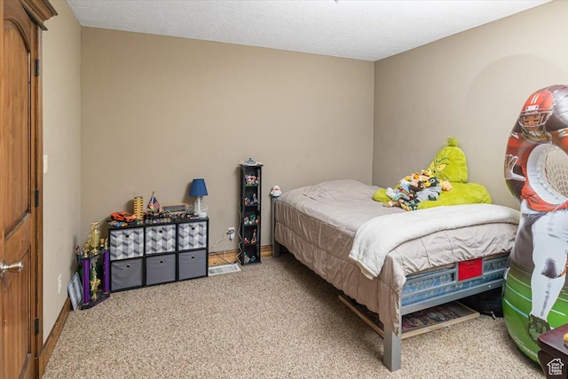 carpeted bedroom featuring a textured ceiling