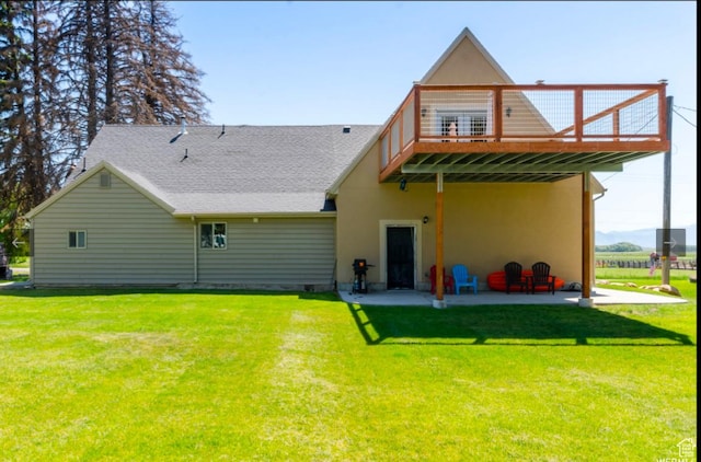 back of house with a yard, a patio, and a deck