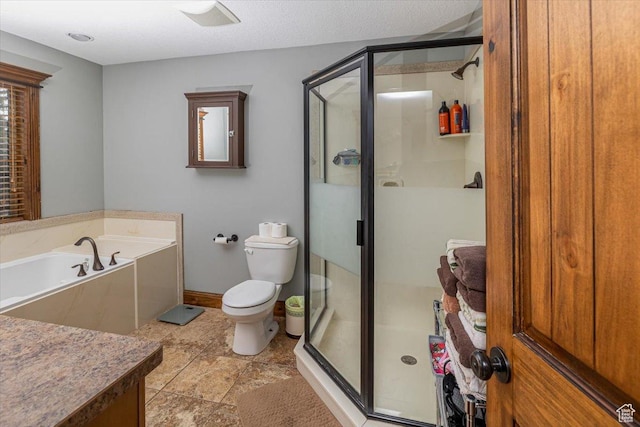 bathroom featuring toilet, plus walk in shower, and a textured ceiling