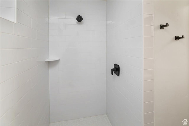 bathroom with tiled shower
