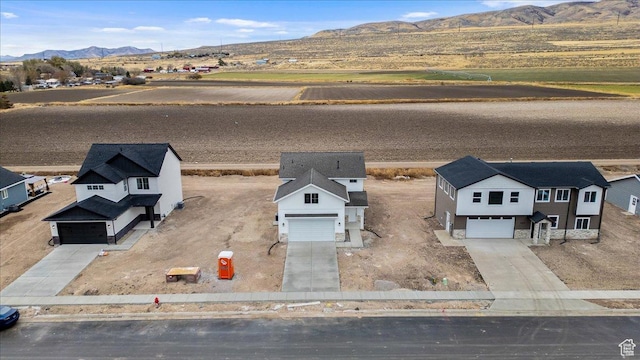 birds eye view of property with a mountain view