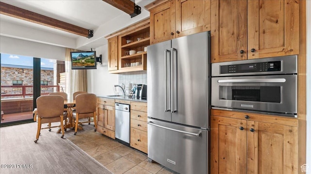 1476 Newpark Blvd Unit 210, Park City, UT 84098 - kitchen featuring appliances with stainless steel finishes, sink, beam ceiling, and decorative backsplash