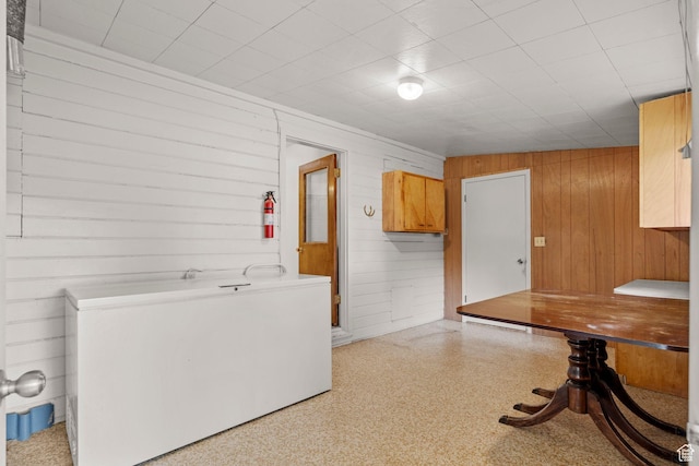 kitchen with wooden walls and refrigerator