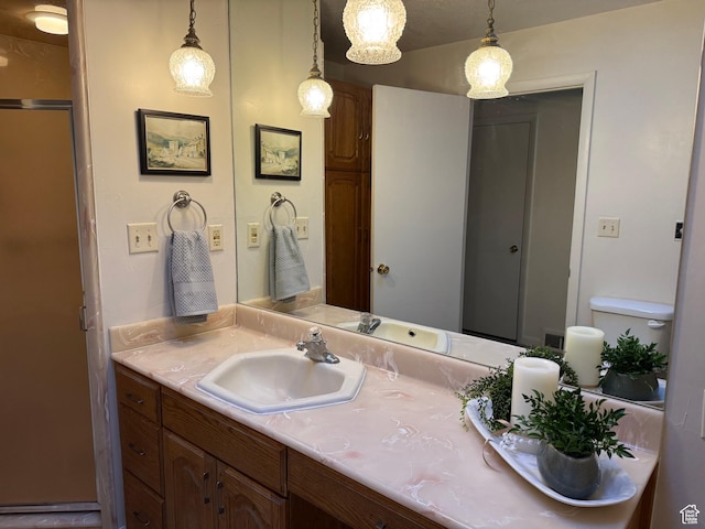 bathroom featuring vanity and toilet