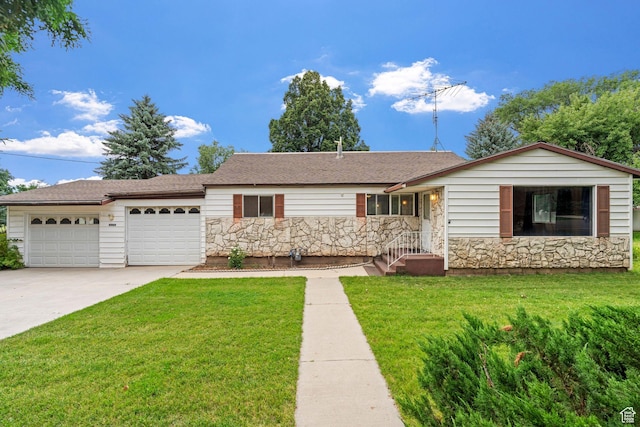 ranch-style house with a garage and a front lawn