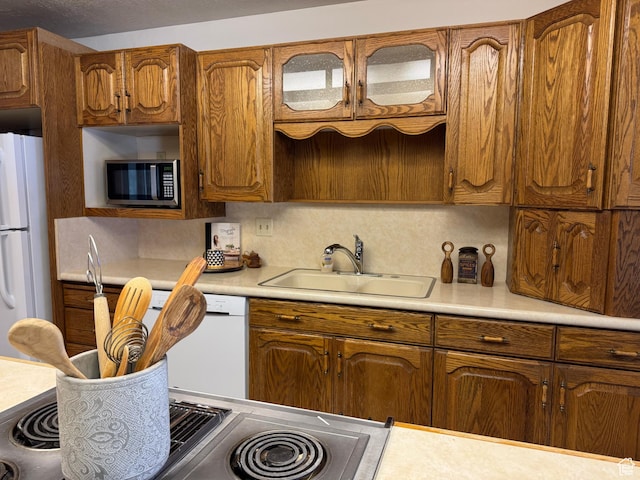 kitchen with sink and white appliances