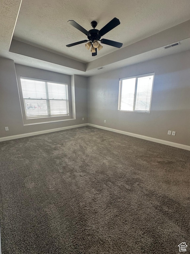 1288 N Cedar Blvd Unit 38-F, Cedar City, UT 84721 - spare room with a textured ceiling, dark carpet, and a tray ceiling