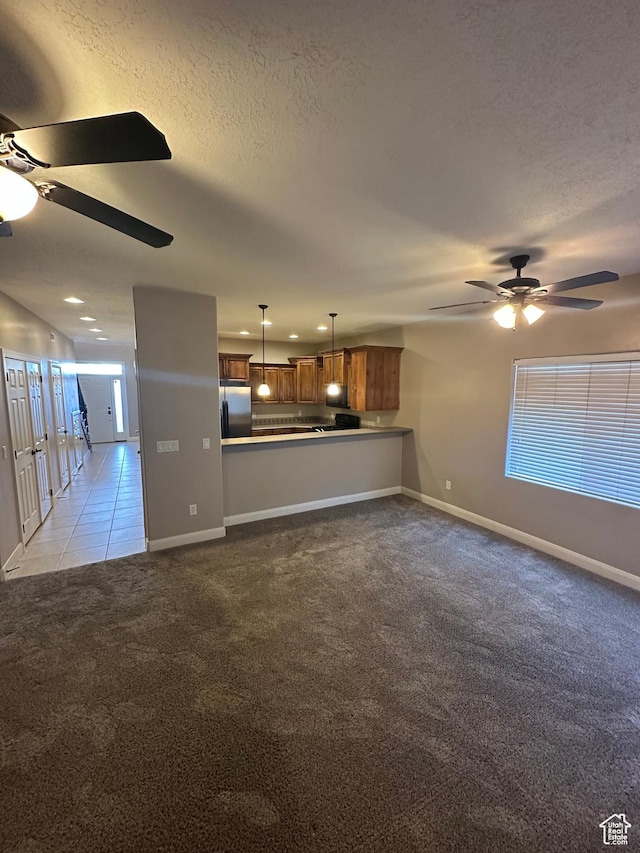 1288 N Cedar Blvd Unit 38-F, Cedar City, UT 84721 - unfurnished living room with ceiling fan, light carpet, and a textured ceiling