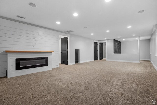 3731 N Tumwater Dr W, Eagle Mountain, UT 84005 - unfurnished living room featuring recessed lighting, a glass covered fireplace, carpet floors, and baseboards