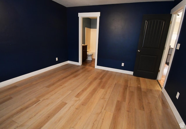 3731 N Tumwater Dr W, Eagle Mountain, UT 84005 - unfurnished bedroom featuring wood finished floors, baseboards, and ensuite bath