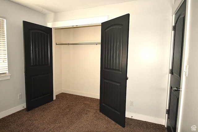 3731 N Tumwater Dr W, Eagle Mountain, UT 84005 - unfurnished bedroom with dark carpet, a closet, and baseboards