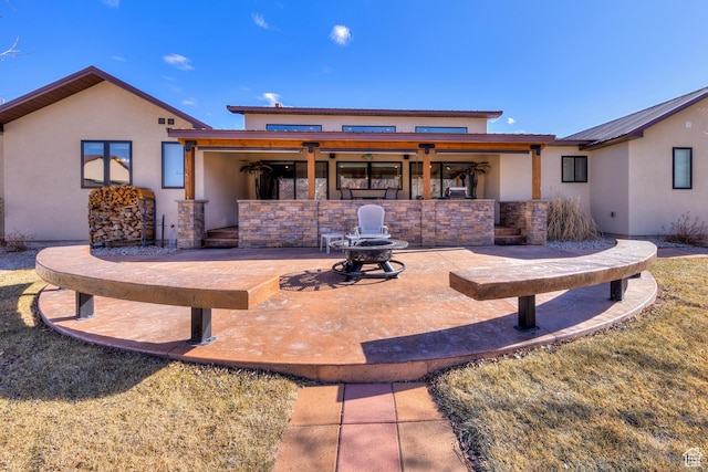 4230 S Beeman Rd, Moab, UT 84532 - back of property featuring a patio area and a fire pit