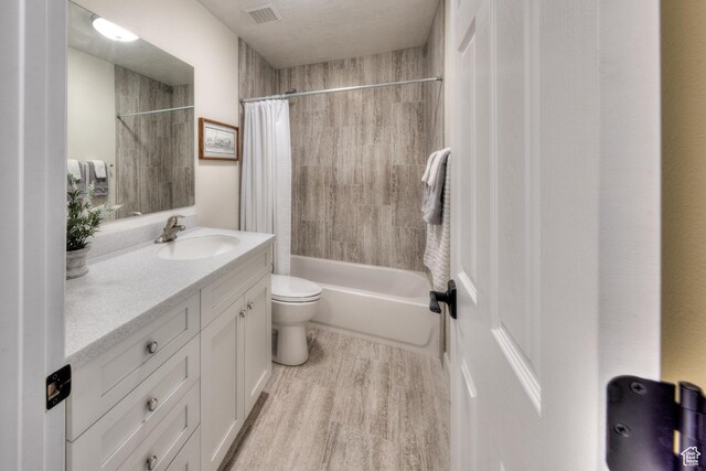 4230 S Beeman Rd, Moab, UT 84532 - full bathroom featuring vanity, toilet, wood-type flooring, and shower / bath combo