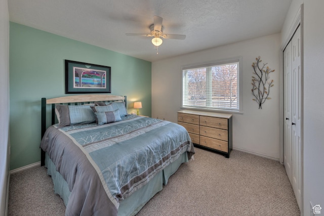 4230 S Beeman Rd, Moab, UT 84532 - bedroom featuring light colored carpet, a textured ceiling, ceiling fan, and a closet