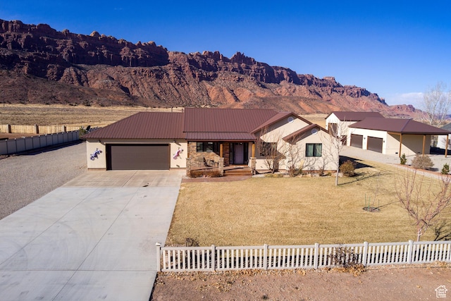 4230 S Beeman Rd, Moab, UT 84532 - ranch-style home featuring a garage, a mountain view, and a front lawn