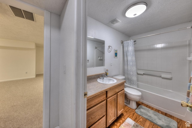 4230 S Beeman Rd, Moab, UT 84532 - full bathroom with shower / bathtub combination with curtain, vanity, wood-type flooring, a textured ceiling, and toilet