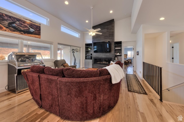 4230 S Beeman Rd, Moab, UT 84532 - living room with high vaulted ceiling, a fireplace, light hardwood / wood-style floors, and ceiling fan