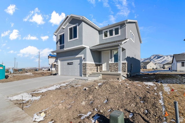 view of front of home with a mountain view and a garage