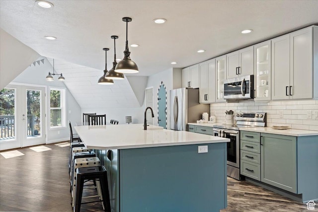 3388 N Eden Hills Dr, Eden, UT 84310 - kitchen with appliances with stainless steel finishes, dark hardwood / wood-style floors, a kitchen breakfast bar, pendant lighting, and a kitchen island with sink