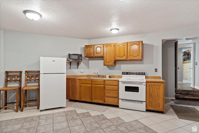 3388 N Eden Hills Dr, Eden, UT 84310 - kitchen featuring light tile patterned flooring, sink, a textured ceiling, and white appliances