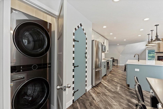 3388 N Eden Hills Dr, Eden, UT 84310 - laundry room with stacked washer / drying machine, sink, and dark hardwood / wood-style floors