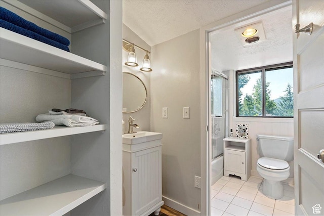 3388 N Eden Hills Dr, Eden, UT 84310 - full bathroom featuring tile patterned floors, toilet, bath / shower combo with glass door, a textured ceiling, and vanity