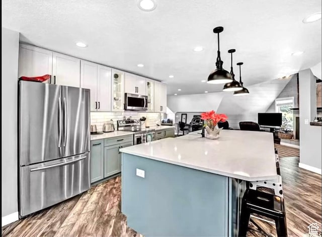 3388 N Eden Hills Dr, Eden, UT 84310 - kitchen featuring pendant lighting, white cabinetry, dark wood-type flooring, and stainless steel appliances