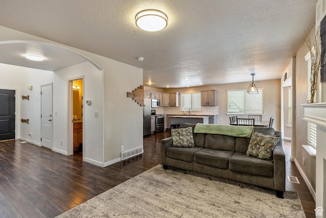 693 N Devonshire Dr, Saratoga Springs, UT 84045 - living room featuring dark wood-type flooring and a textured ceiling