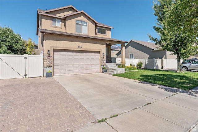 693 N Devonshire Dr, Saratoga Springs, UT 84045 - view of front of property featuring driveway, stucco siding, an attached garage, stone siding, and a gate