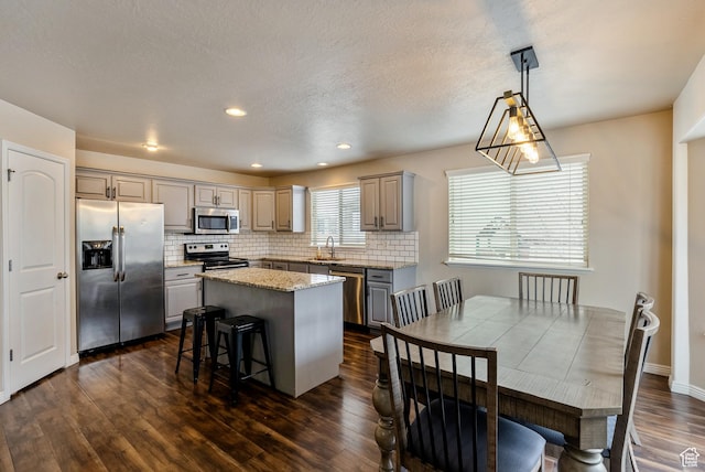 693 N Devonshire Dr, Saratoga Springs, UT 84045 - kitchen with decorative light fixtures, gray cabinetry, dark hardwood / wood-style flooring, a center island, and stainless steel appliances