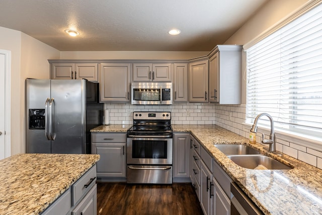 693 N Devonshire Dr, Saratoga Springs, UT 84045 - kitchen with sink, dark hardwood / wood-style floors, gray cabinets, stainless steel appliances, and light stone countertops