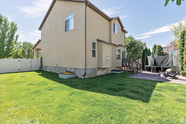 693 N Devonshire Dr, Saratoga Springs, UT 84045 - rear view of house with a gate, a patio, and stucco siding