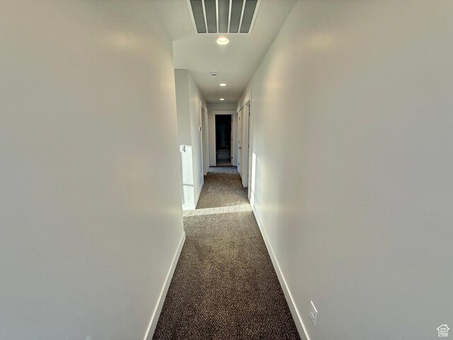 hall with recessed lighting, visible vents, light colored carpet, and baseboards