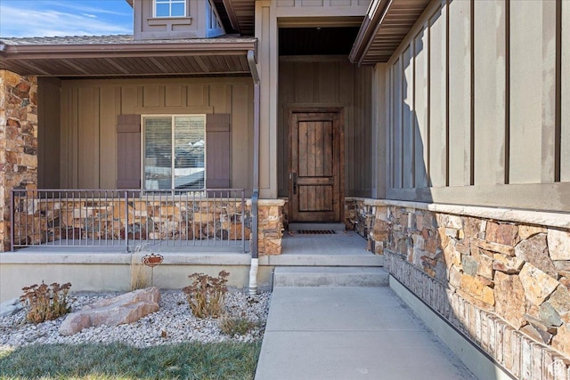 1321 Highland Blvd N, Brigham City, UT 84302 - doorway to property featuring stone siding, a porch, and board and batten siding