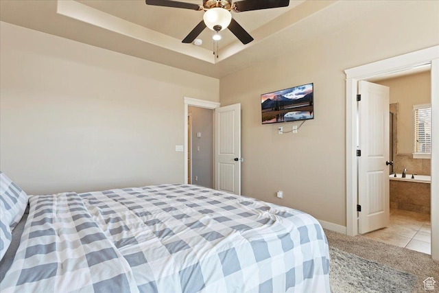 1321 Highland Blvd N, Brigham City, UT 84302 - bedroom with light carpet, baseboards, a tray ceiling, light tile patterned floors, and a ceiling fan
