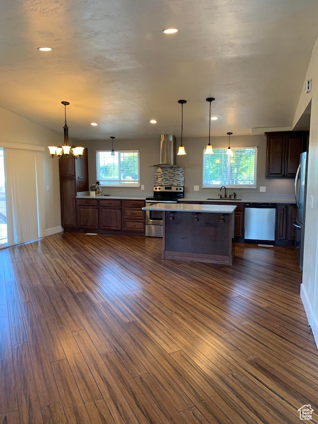 685 W 2550 S, Price, UT 84501 - kitchen featuring dark hardwood / wood-style flooring, hanging light fixtures, exhaust hood, dark brown cabinetry, and stainless steel appliances