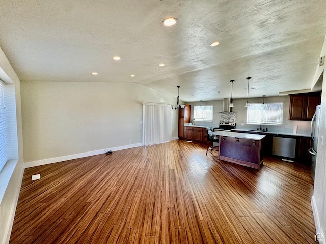 685 W 2550 S, Price, UT 84501 - kitchen with pendant lighting, wall chimney range hood, dark wood-type flooring, dishwasher, and a center island