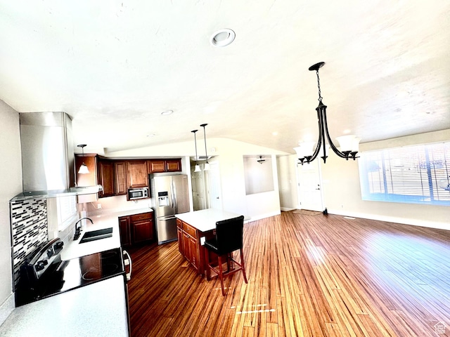 685 W 2550 S, Price, UT 84501 - kitchen with sink, vaulted ceiling, hanging light fixtures, appliances with stainless steel finishes, and a kitchen island