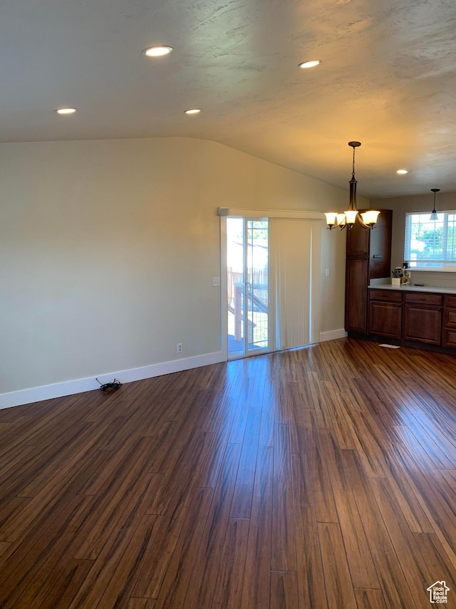 685 W 2550 S, Price, UT 84501 - empty room featuring dark hardwood / wood-style floors, vaulted ceiling, and a notable chandelier