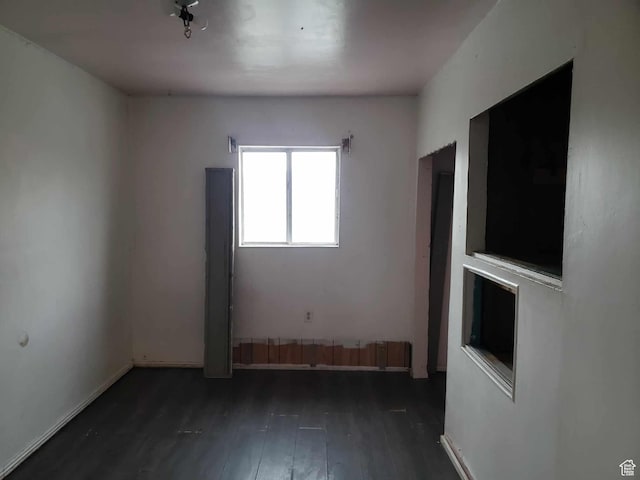 empty room with dark wood-type flooring