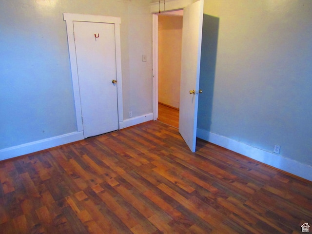unfurnished bedroom featuring dark wood-type flooring