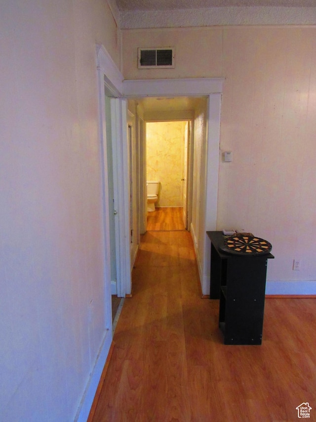 hallway with hardwood / wood-style flooring