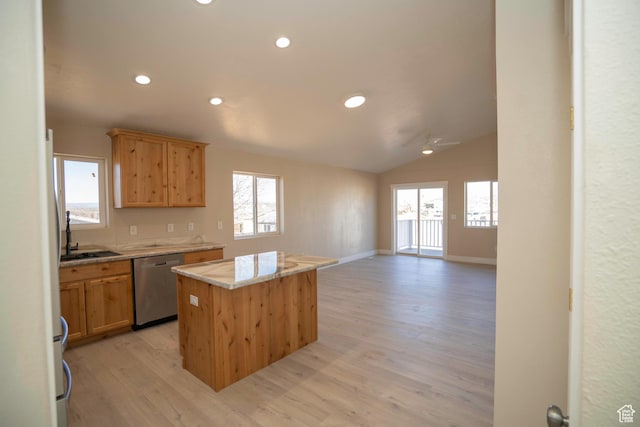 kitchen with lofted ceiling, sink, a center island, stainless steel dishwasher, and light wood-type flooring